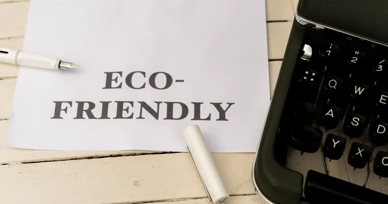a piece of paper that says eco - friendly next to a typewriter