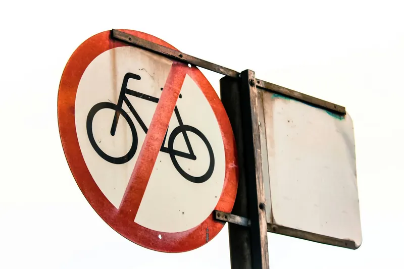 A close-up of a weathered 'No Bicycles Allowed' street sign, emphasizing traffic restrictions.